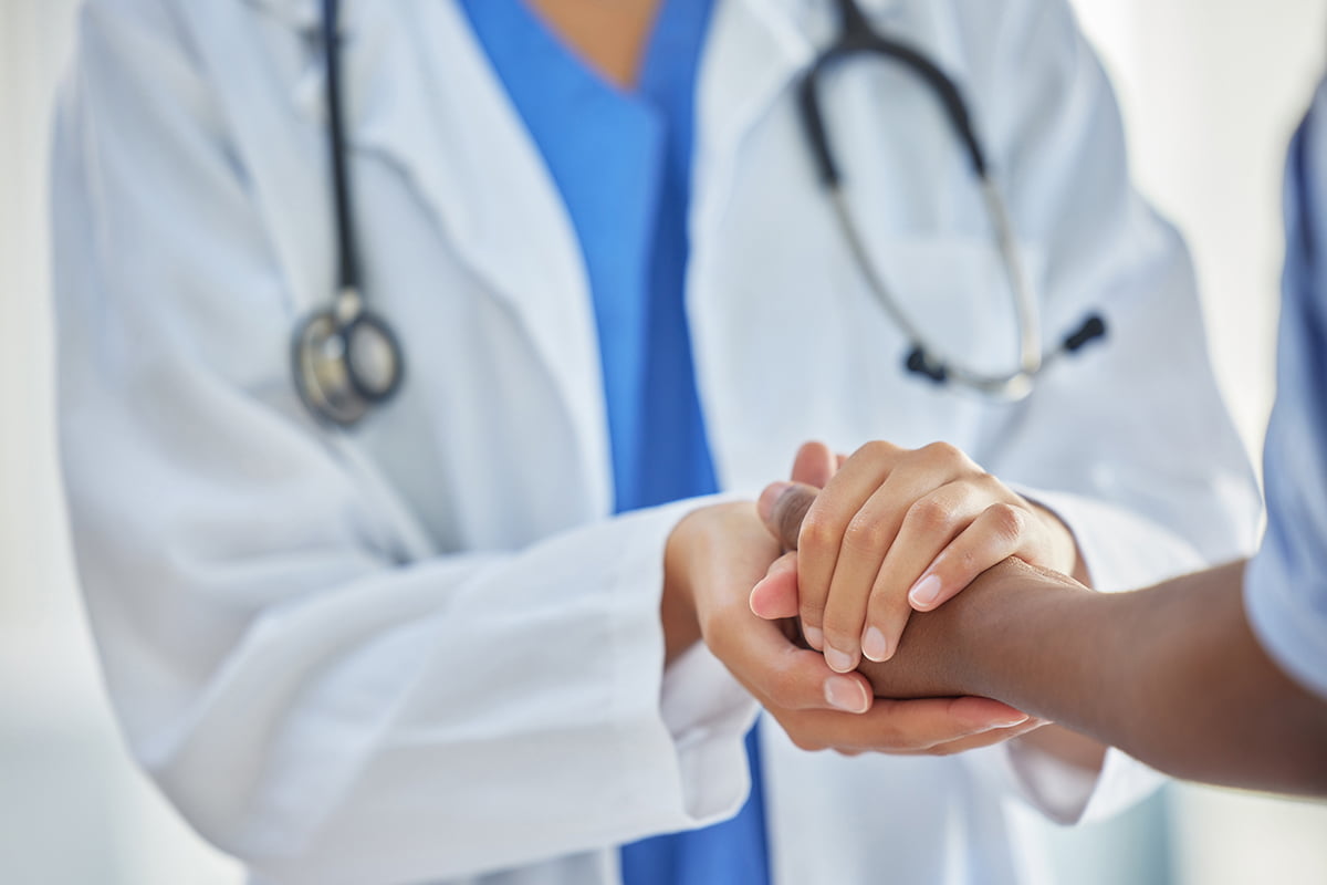 Doctor holding the patient's hand